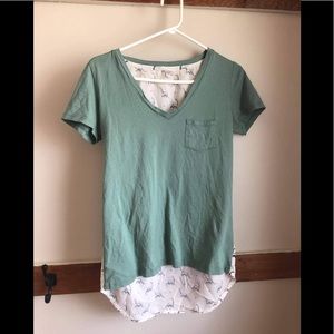 TWIK | V-neck light green tee with cute dinausor patterns on the back. Size S.